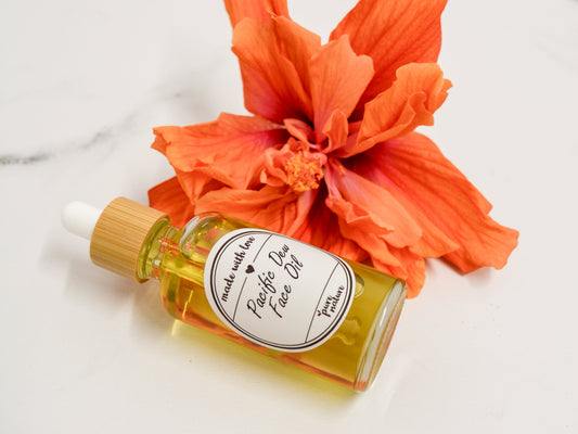 Bottle of face oil with hibiscus flower