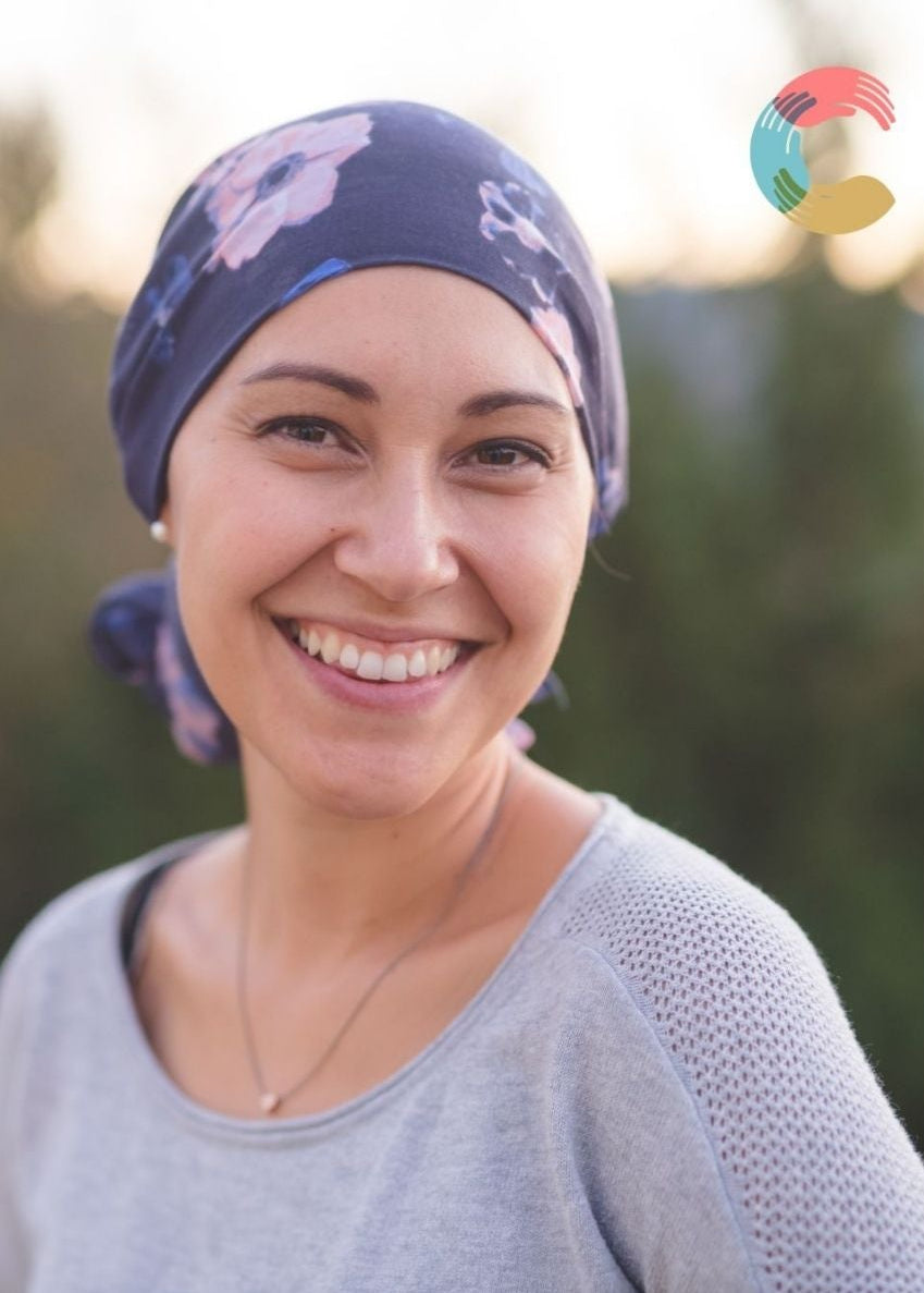 Woman wearing a headscarf with a blurred outdoor background
