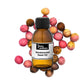 100ml amber bottle of Sandalwood Seed Oil sitting on top of Sandalwood Seeds