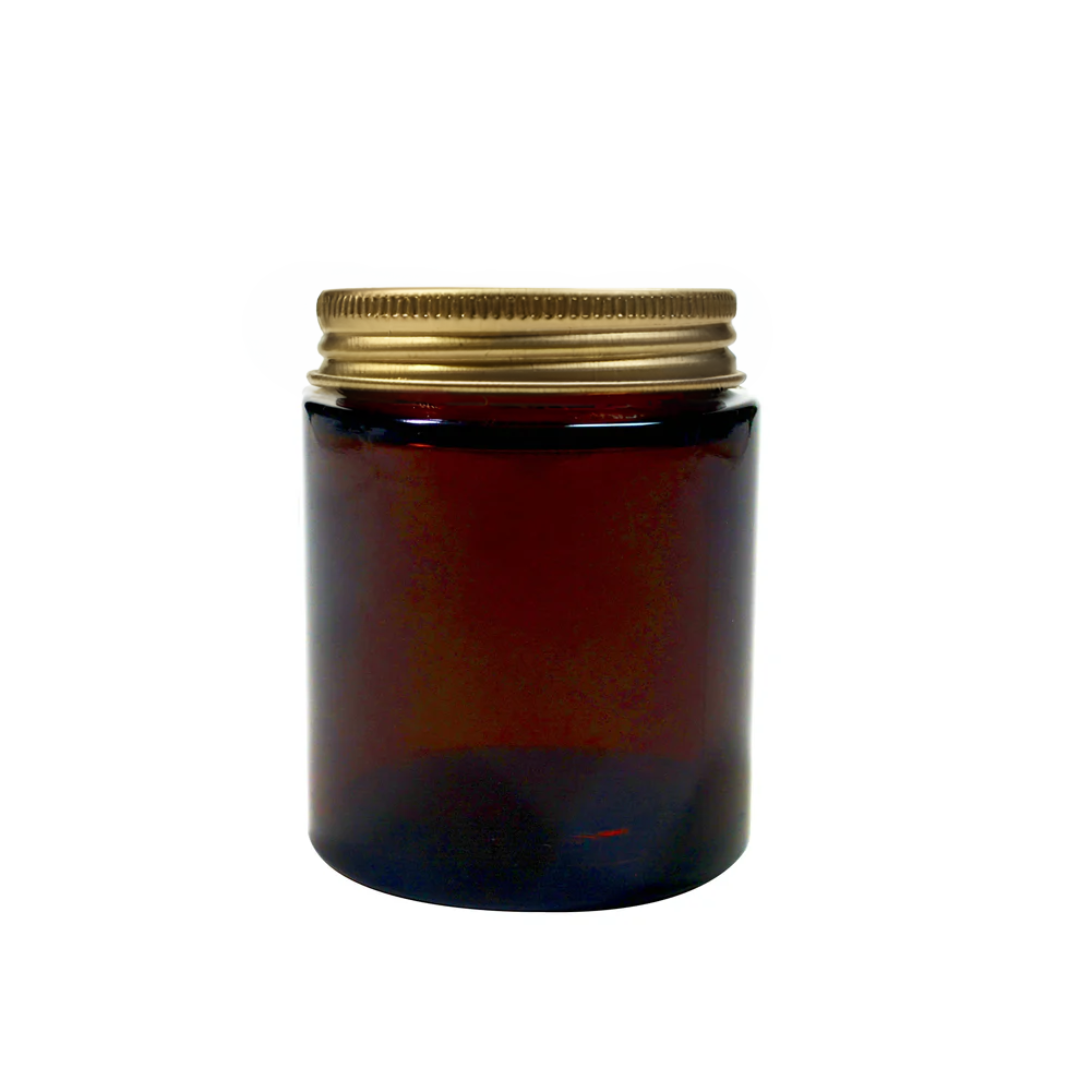 Amber 100ml glass pot for packaging by purenaturenz, showcasing a clear glass container with a rounded shape and smooth finish.