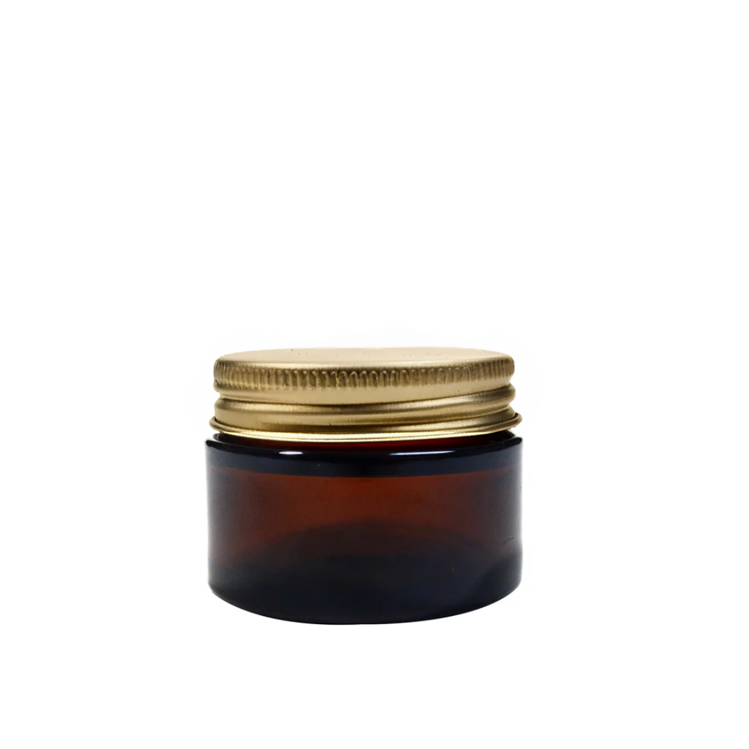 Amber 30ml glass pot for packaging by purenaturenz, featuring a clear glass container with a gold-colored lid.