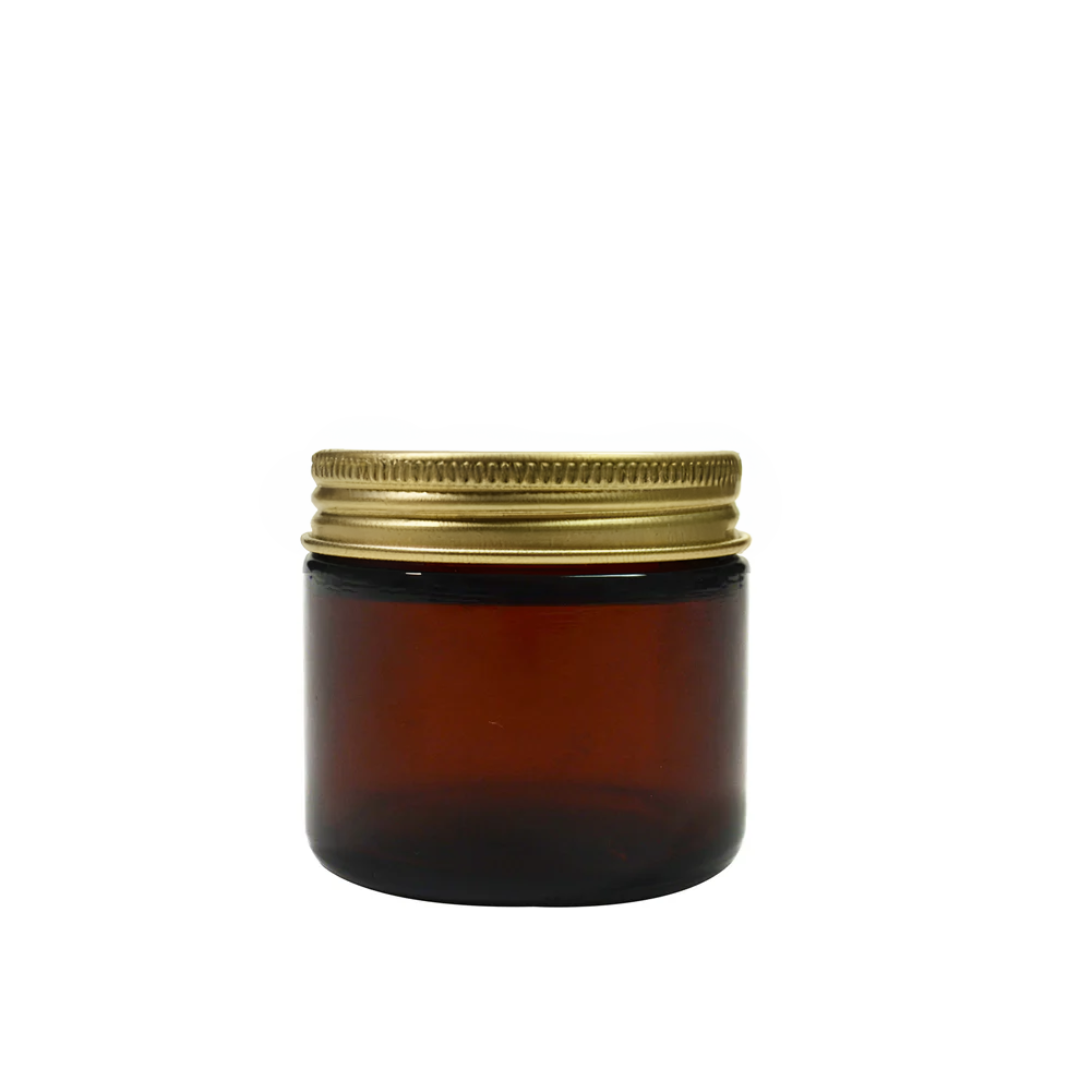 Amber 60ml glass pot for packaging by purenaturenz, featuring a clear glass container with a gold-colored lid.