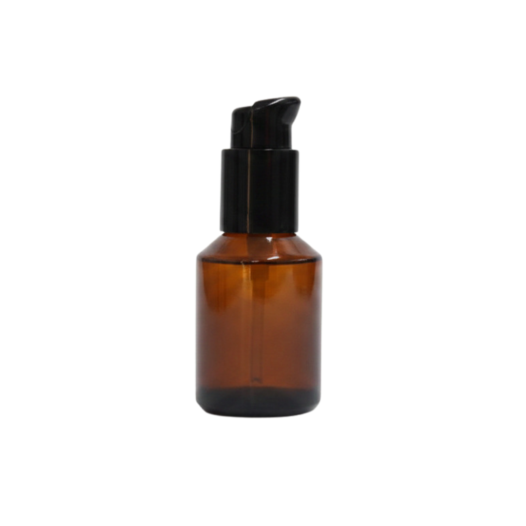 Amber glass bottle with black pump on a white background