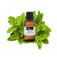 Bottle of purenaturenz marjoram essential oil with fresh marjoram herbs on a neutral background.