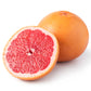 Pink grapefruit essential oil from purenaturenz, showing a vibrant pink grapefruit and a small amber glass bottle of essential oil.