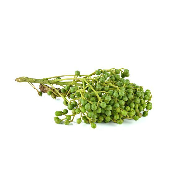 Litsea cubeba (May Chang) essential oil in a glass bottle with fresh yellow-green leaves and May Chang fruit on a wooden surface.