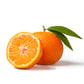 Purenaturenz Tangerine Essential Oil bottle with fresh tangerine slices and leaves on a white background.
